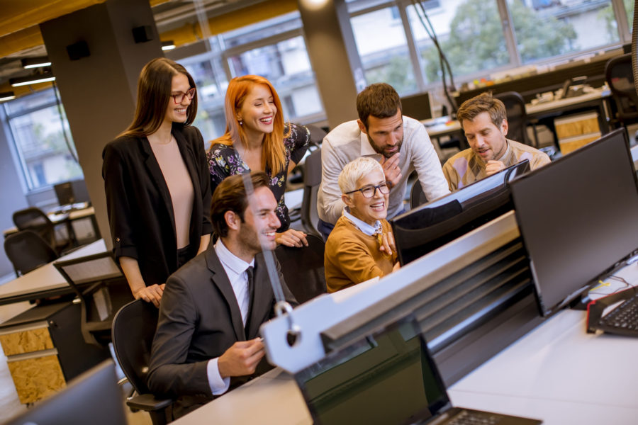 Senior businesswoman working together with young business people