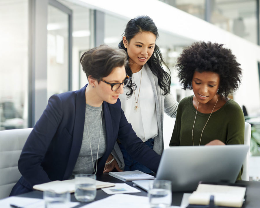 Collaboration d’une équipe autour d’un ordinateur pour des services IT destinés aux PME wallonnes