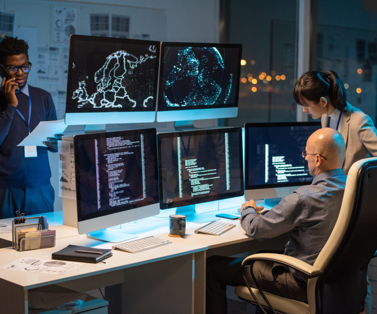 Two colleagues sitting in front of computer monitors with decoded data